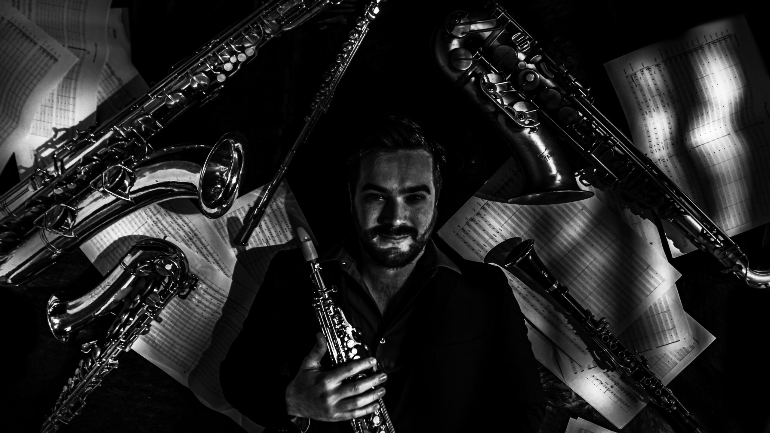 Black-and-white portrait of Lorenzo Ferrero with woodwind instruments
